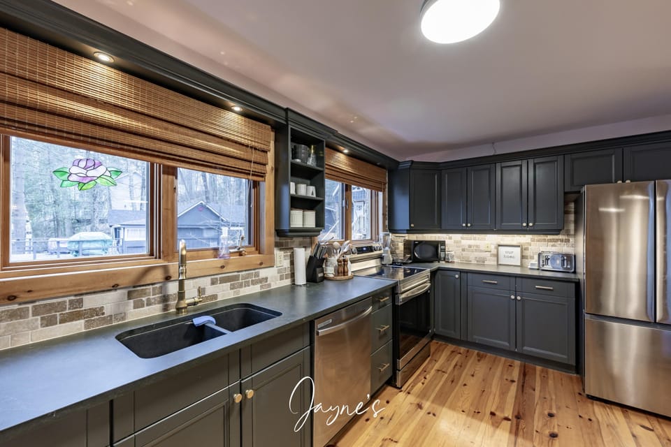 Spacious kitchen with modern appliances and scenic window views