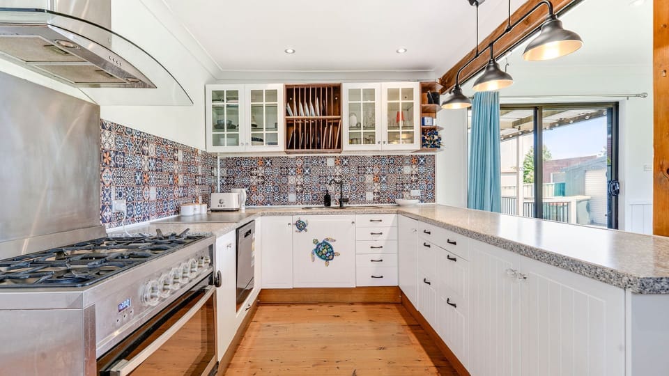 Fully equipped kitchen with modern appliances and ample bench space
