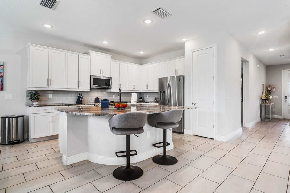 Open kitchen with granite counters and spacious island seating.