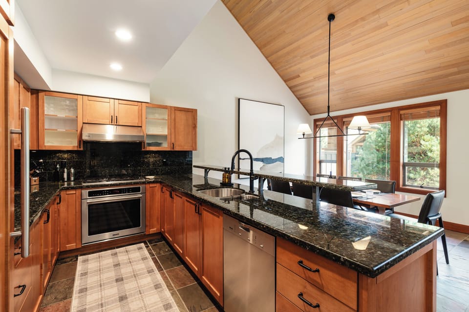 Kitchen - Fully equipped with modern appliances for home cooking and breakfast seating for up to 3.