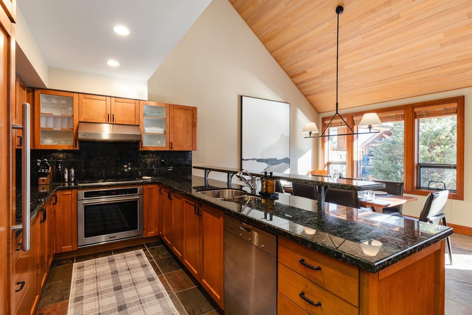 Kitchen - Fully equipped with modern appliances for home cooking and breakfast seating for up to 3.