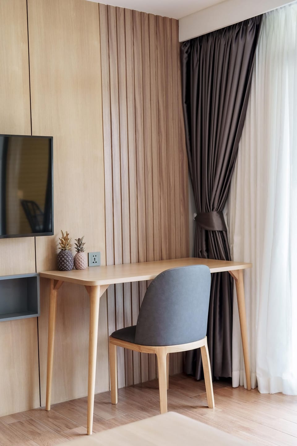 Multi-purpose work and relaxation area featuring a desk, chair and TV for added comfort.