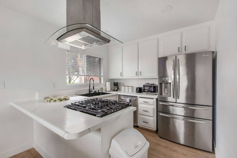 Fully stocked kitchen with cooking supplies and a drip coffee maker