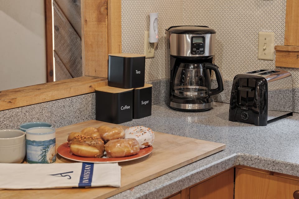 Warm, wood-finished kitchen equipped with modern appliances and everything you need for home-cooked meals.