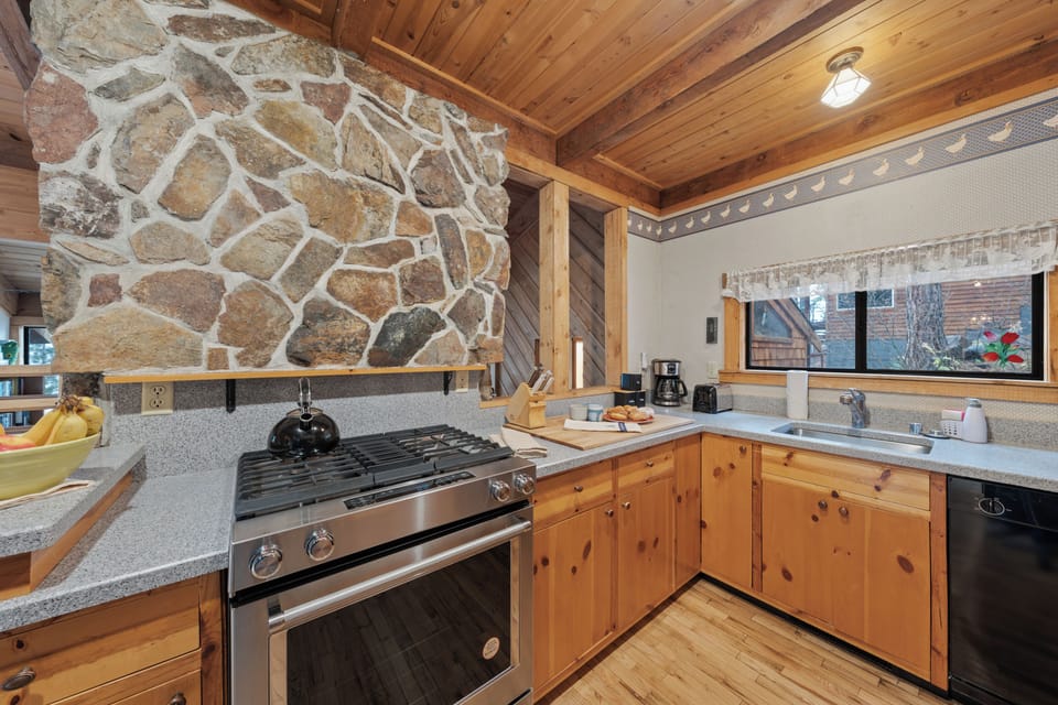 Warm, wood-finished kitchen equipped with modern appliances and everything you need for home-cooked meals.