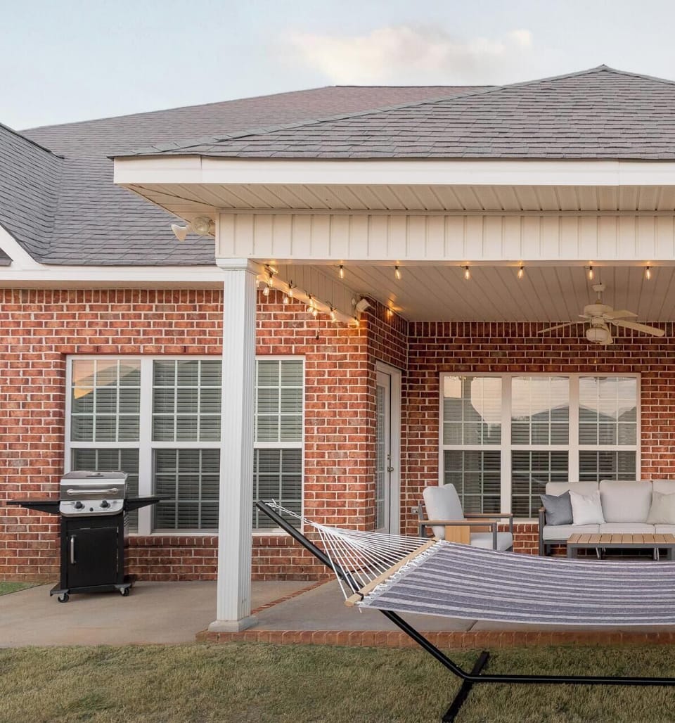 Fenced Back yard w/patio seating, grill, and yard games