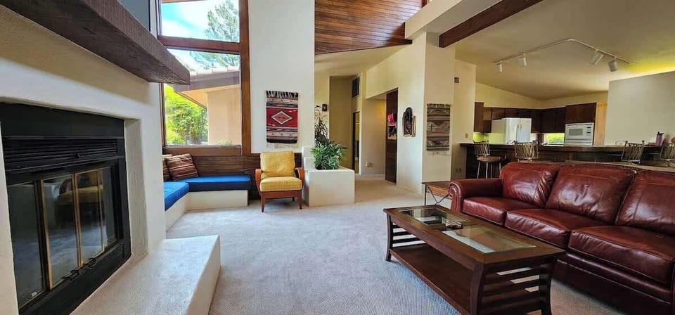 Living room with fireplace, leather seating and Smart TV