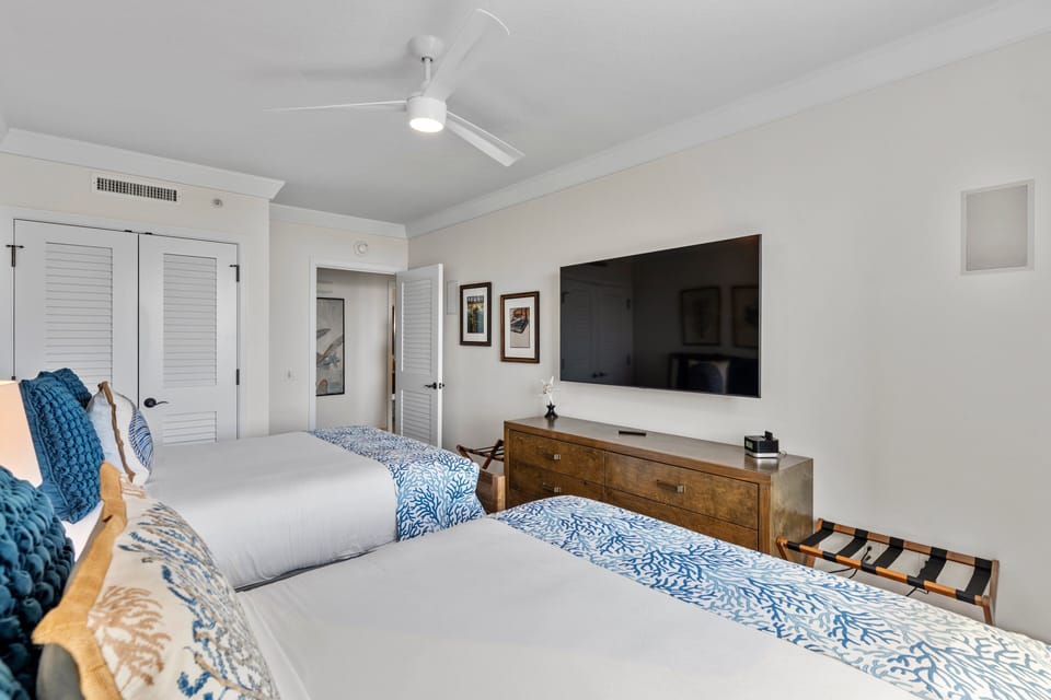 Comfortable twin layout with media access and soft lighting for a restful stay