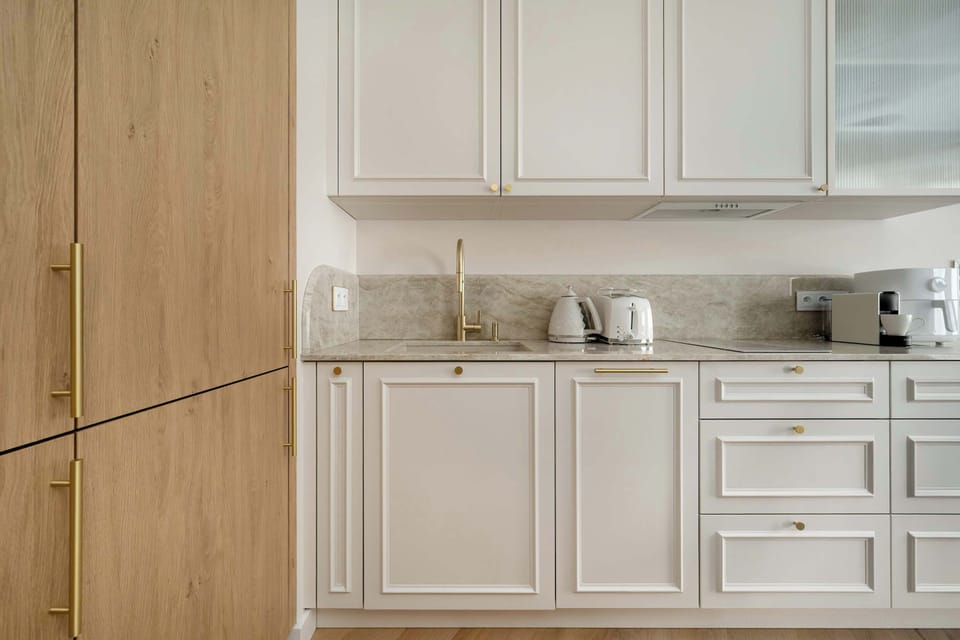 Modern kitchen corner with light cabinetry and wooden accents.