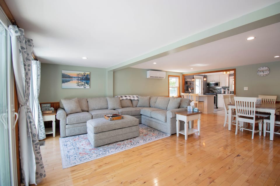 Bright and spacious living room featuring a large, comfortable sofa.
