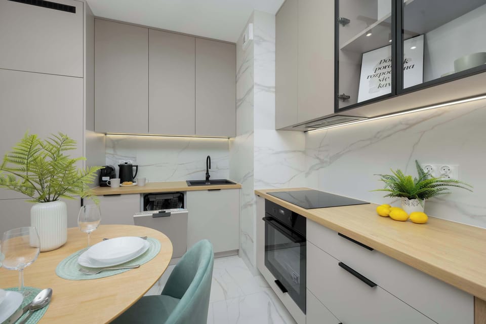 The sleek design of the kitchenette blending seamlessly with the living area.