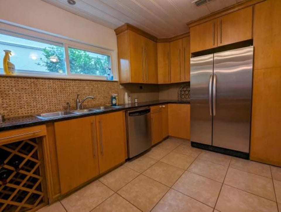 Kitchen, view of sink and full size refrigerator 