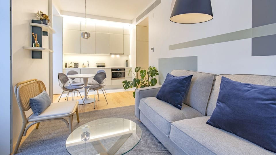 Spacious modern living area with blue-grey accents and natural light in the heart of Lisbon.

#andoliving #lisbon #modern #relax
