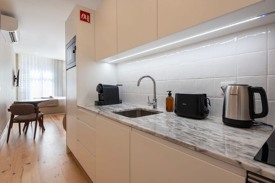 The minimalist design and premium finishes add an element of sophistication to our kitchenette. Soft under-cabinet lighting highlights the immaculate countertops.