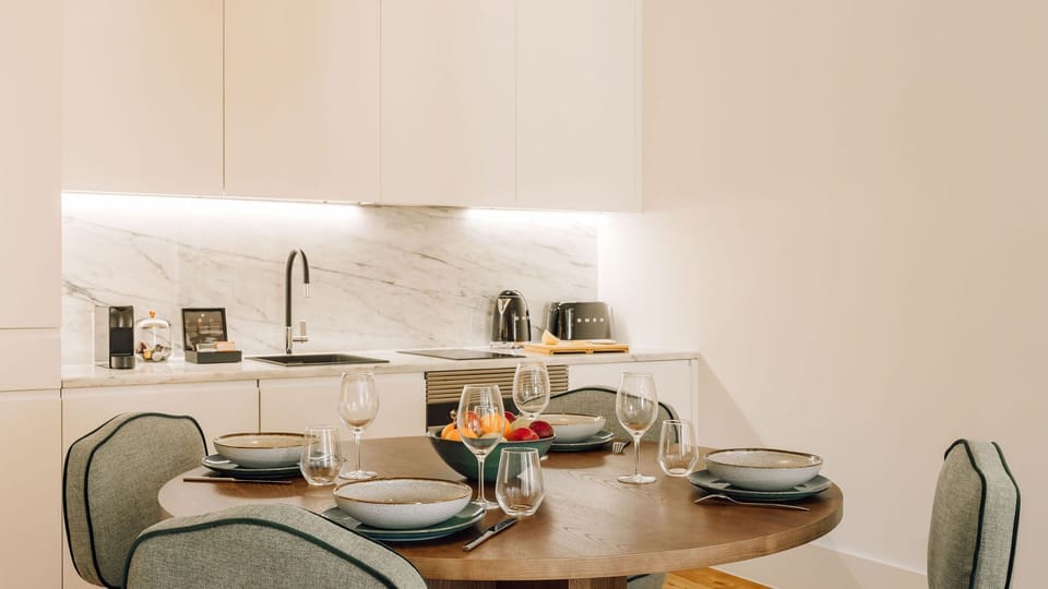 Modern dining and living space with natural light, warm wood flooring, minimalist furniture, and stylish decor. 
#InteriorDesign 
#ModernLiving 
#CozyHome 
#Minimalism
#AndoLiving