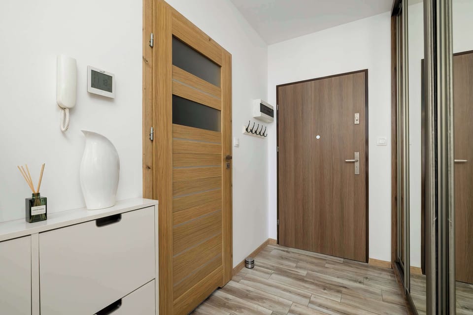 Hallway with wooden doors and elegant décor accents.