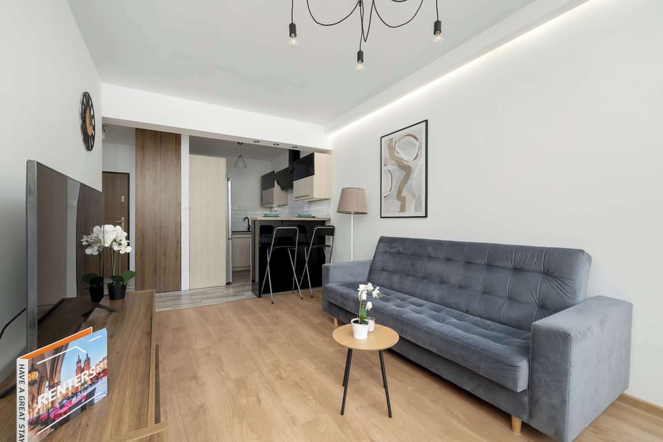 Open-plan living room with natural light and cozy seating.