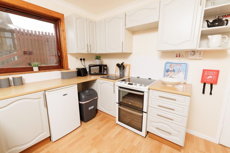 Kitchen with oven, fridge, and counter space