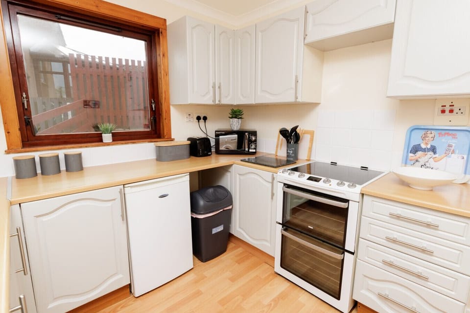 Kitchen with oven, fridge, and counter space