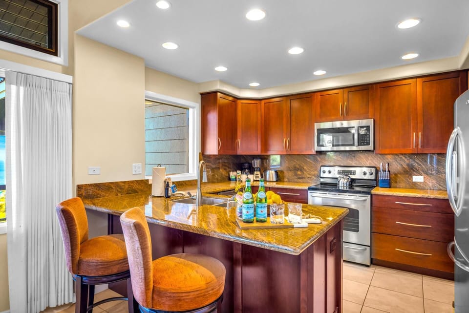 Granite countertops, stainless appliances, and bar seating make this kitchen functional and guest-ready.