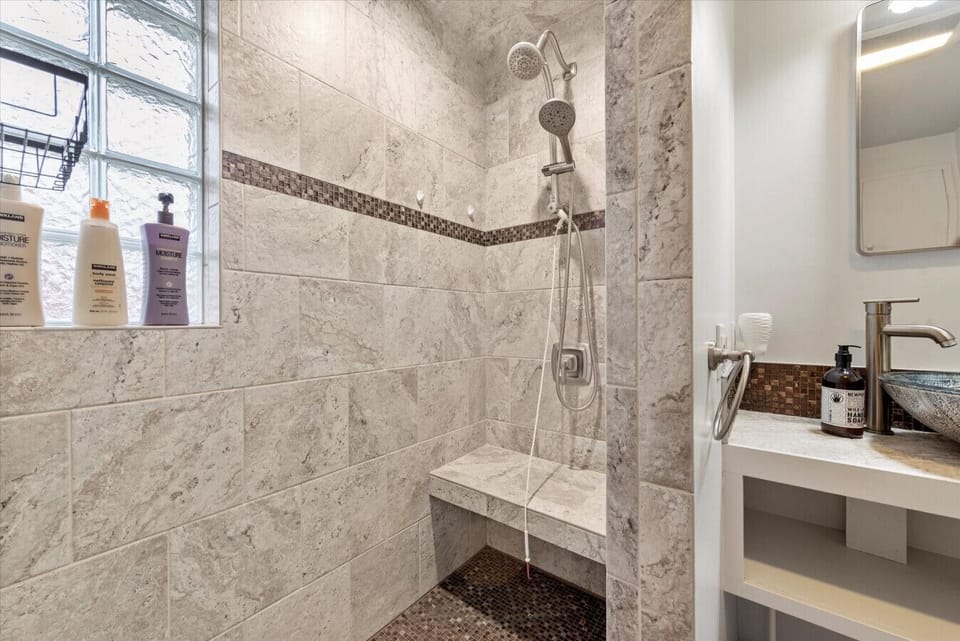 You will love this custom tile shower with a bench.