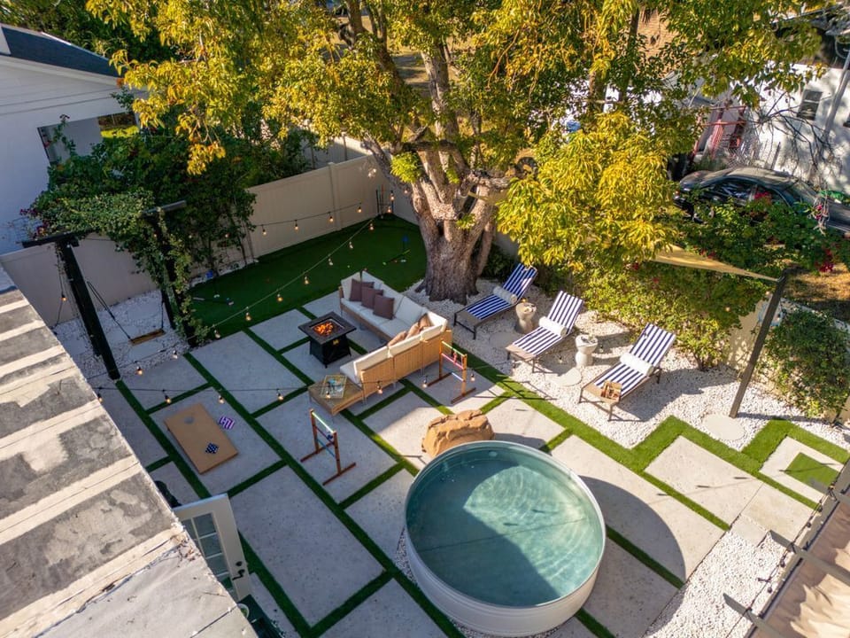Aerial view of your complete backyard retreat - from pool to fire pit to games, everything you need for the perfect stay