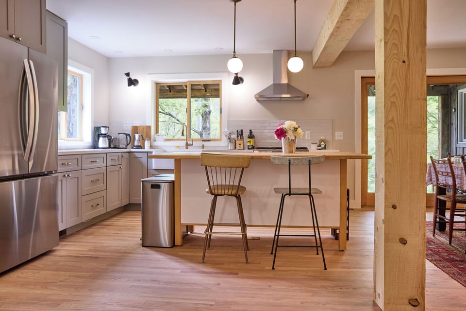 Modern open-concept kitchen with butcher block island and stainless steel applia