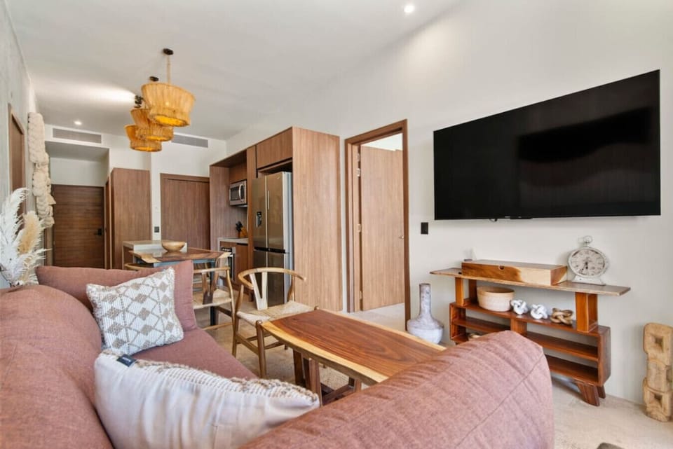 Unwind in a cozy, sunlit living space — clean, comfy, and ready for your next TV binge!