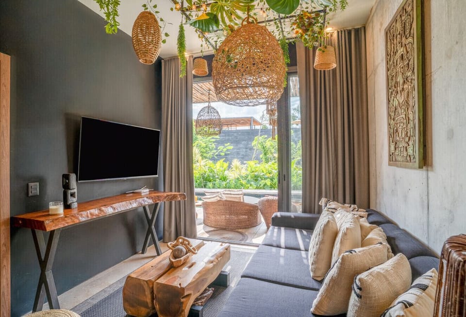 Gather, unwind, and enjoy the comfort of this stylish living space featuring cozy seating, handcrafted details, and seamless access to the outdoor terrace.