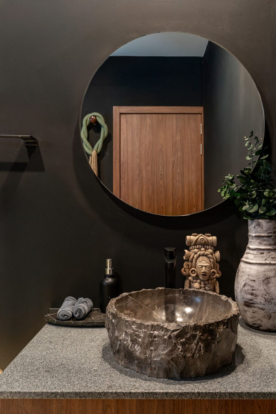 Enjoy a sophisticated bathroom experience featuring unique handcrafted accents, contemporary design, and a warm ambiance inspired by Tulum`s natural charm.