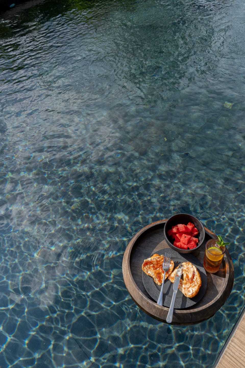 Savor the luxury of poolside living, where refreshing drinks, tropical treats, and tranquil waters create the perfect vacation experience.