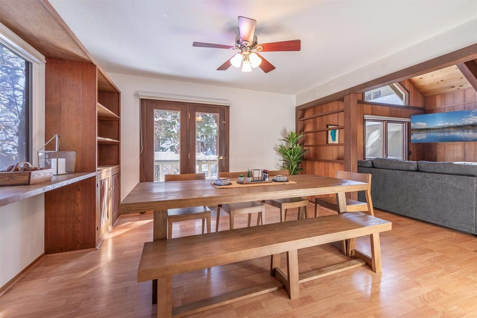 Friends and family alike can gather around this beautiful wooden dining table where warm memories are made, surrounded by rich wood details and natural light.