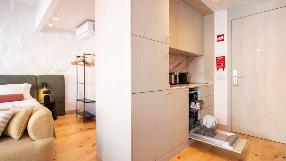 Modern kitchen with dishwasher and induction hob — designed for better stays. #ExtendedStay #FunctionalDesign #PortoAirbnb