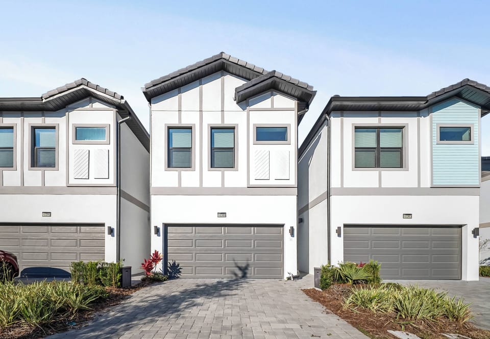 Discover a charming facade that beautifully combines modern architecture with traditional accents. The vibrant landscape boosts curb appeal, while the spacious driveway ensures a convenient and welcoming arrival for all guests.