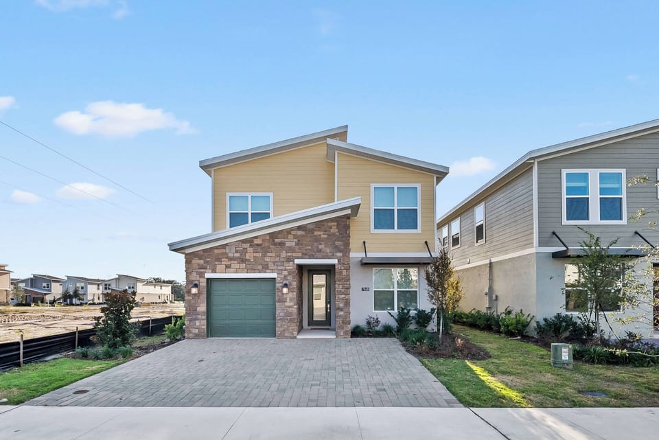 Enjoy a charming exterior with warm beige and stone accents, large windows that fill the space with natural light, and a beautifully landscaped yard that creates an inviting first impression for your stay.