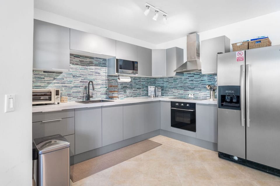 Newly installed, fully equipped kitchen with oven, refrigerator and freezer, microwave, coffee maker, and essentials.