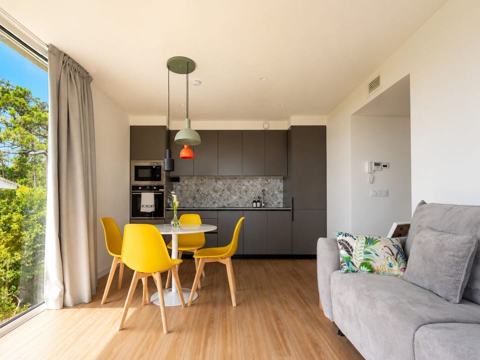 A fully equipped kitchen with modern design and natural light to feel at home.