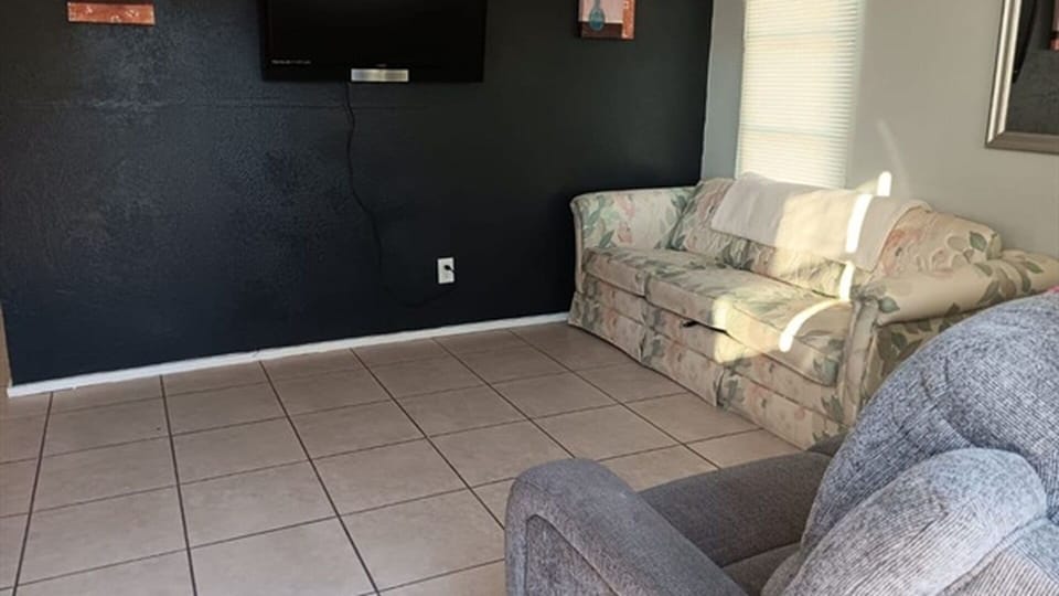 Living room seating area with wall-mounted TV