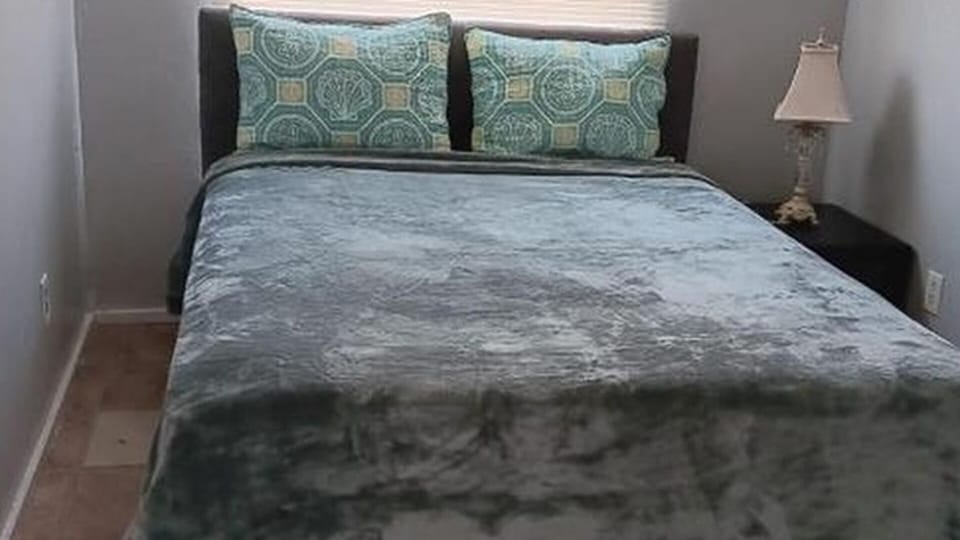 Bedroom with large bed, pillows, and window