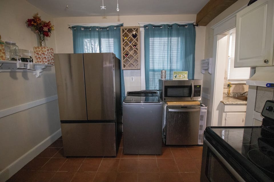 Modern full kitchen featuring stainless steel appliances