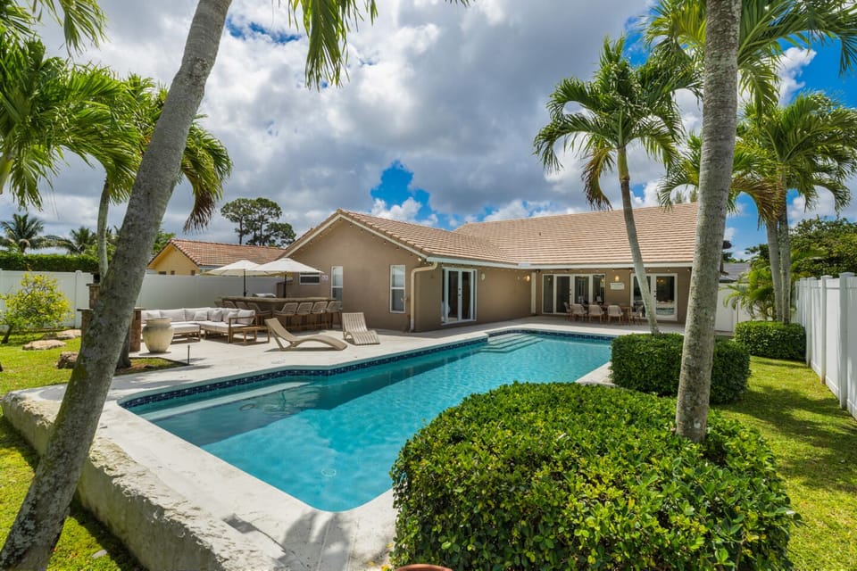 Spacious backyard oasis with a luxurious saltwater pool and pool cage for privacy.