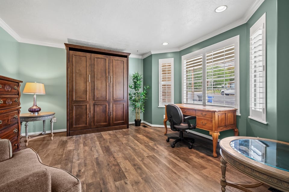 Spacious, light-filled office with a desk and seating area that easily transforms into an extra bedroom with a queen-size Murphy bed.