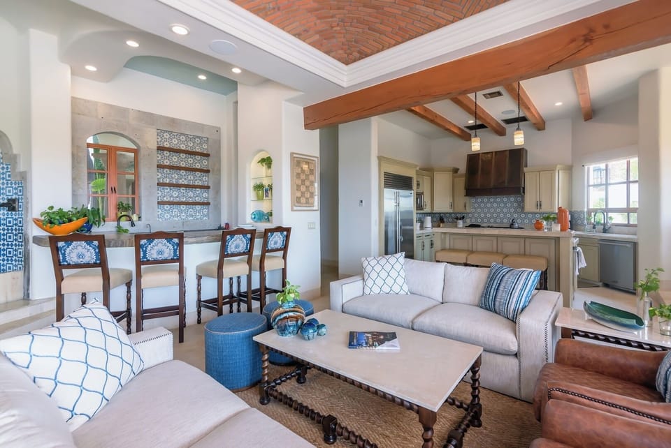 Open-concept living area with luxury furniture, seamlessly connecting living, dining, and kitchen spaces for an elevated guest experience.
