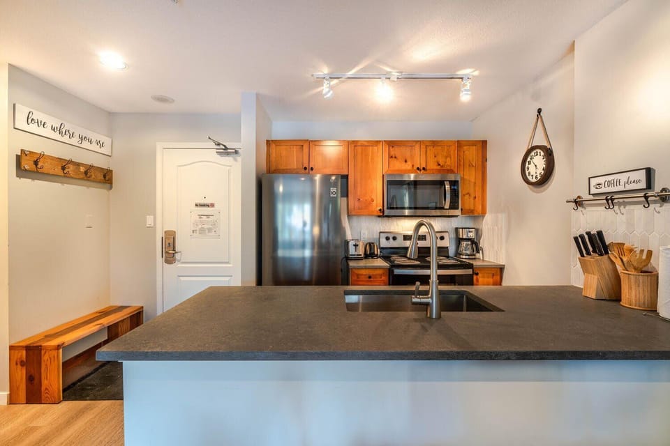 Prepare meals with ease in this clean, functional, and well-stocked kitchen.