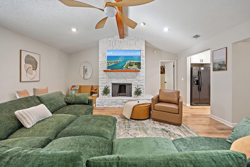 Spacious living room with 65 inch television.