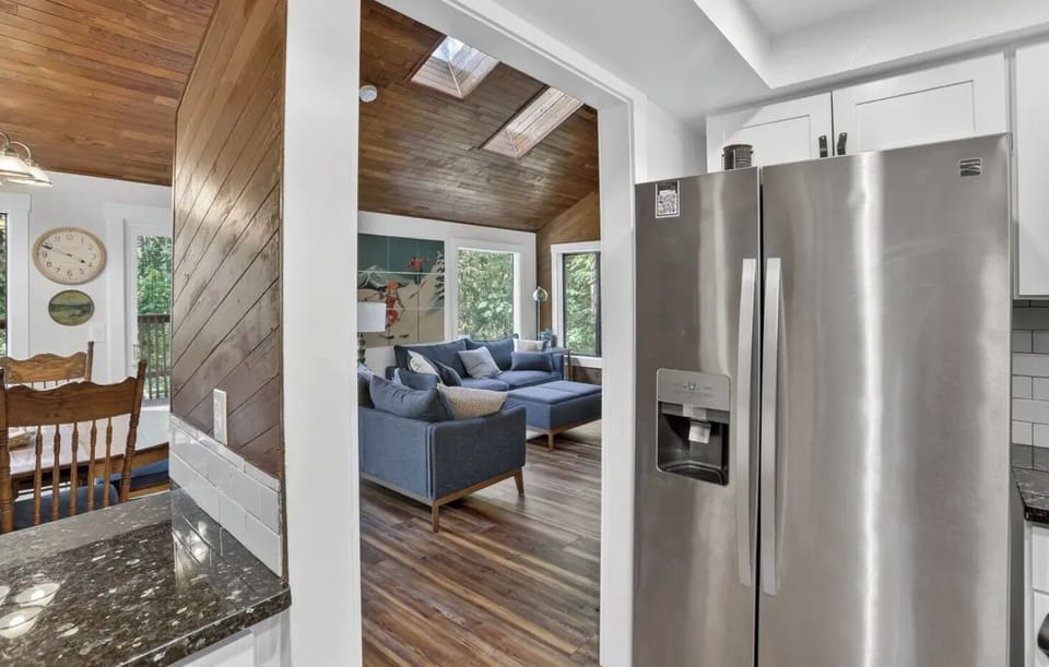 Open floor plan flows between living room, dining area and kitchen