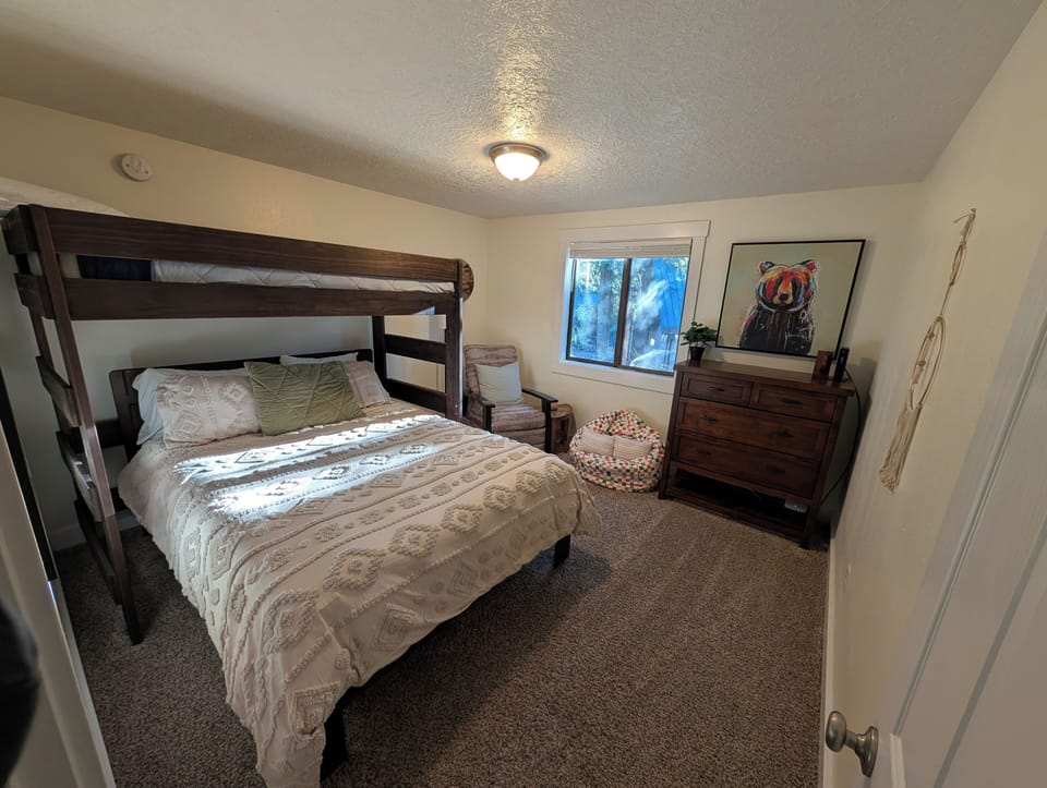 Upstairs bedroom with queen bed and twin bunk above