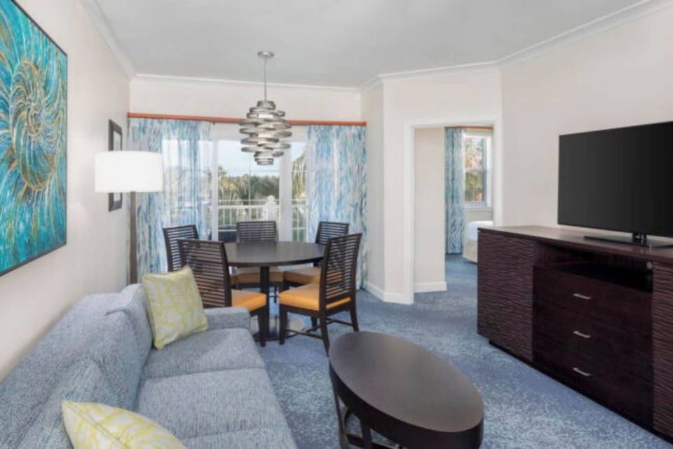 Spacious living area with a sleeper sofa, and separate dining area.