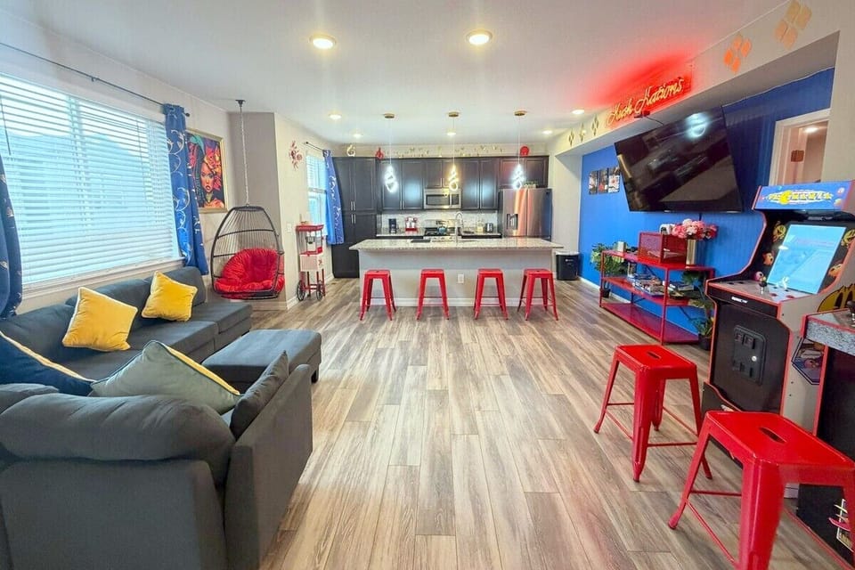 The ultimate hangout spot! Relax on the spacious sectional, play a round on the arcade cabinet, or lounge in the hanging egg chair. Features a fully equipped kitchen with breakfast bar seating, perfect for socializing while cooking.