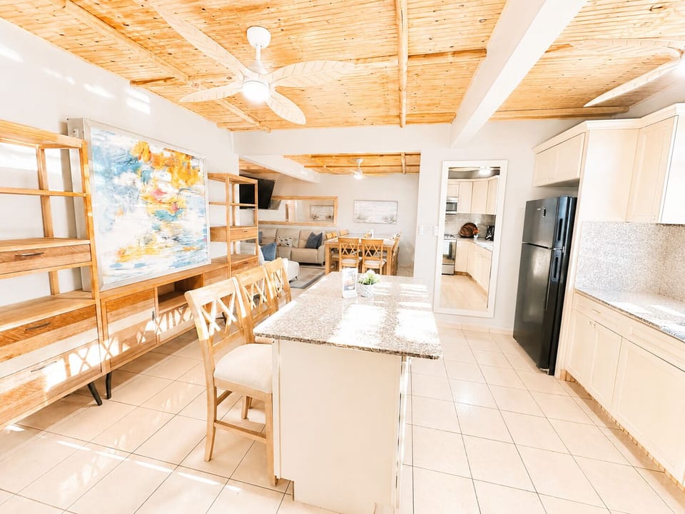 Downstairs Kitchen with Bar Seating and Large Marble Table. 